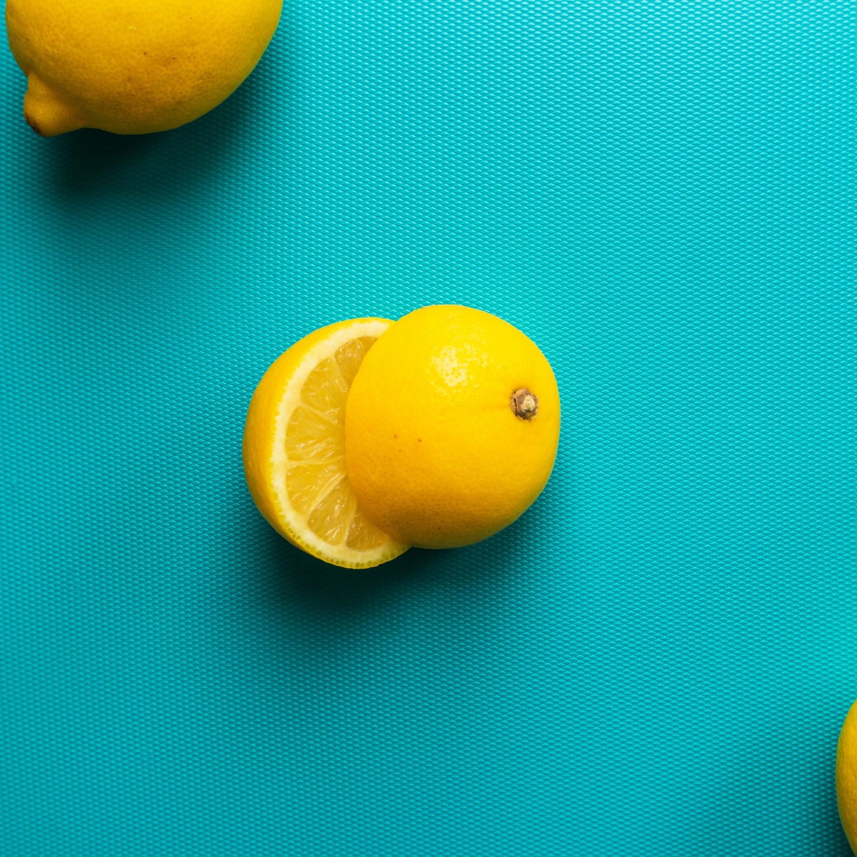 Glamorous photo of three lemons, one sliced