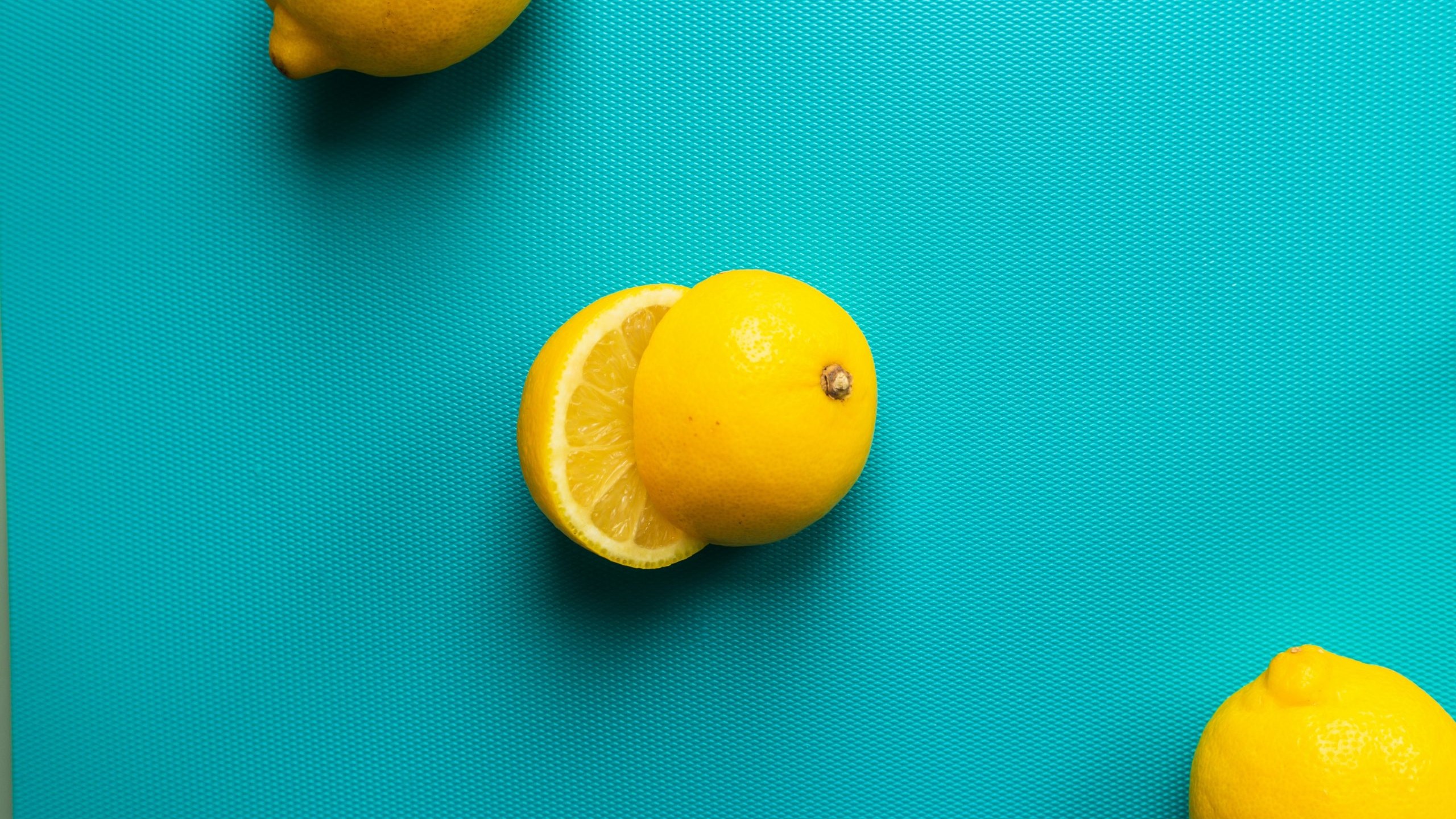 Glamorous photo of three lemons, one sliced